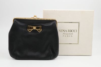 a small black purse with a gold bow on the front