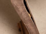 close up of a wooden chair with a hole in the back
