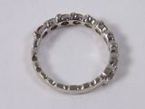 a close up of a silver ring on a white surface