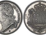 a close up of a coin with a crown on top of it