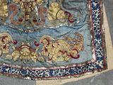 a blue cloth with gold and red designs on it
