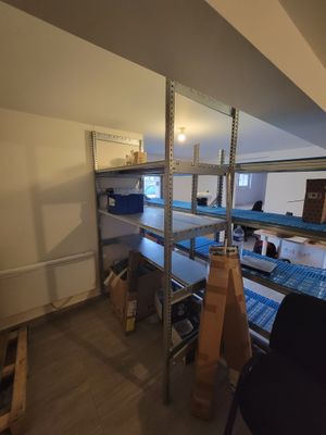 a room with a lot of boxes on the shelves