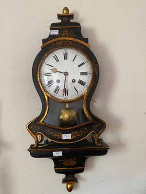two clocks on the wall that are hanging on the wall