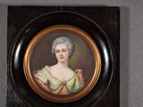 portrait of a woman in a green dress in a black frame