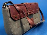 an image of a brown and grey purse on a blue background