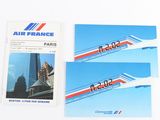two booklets of air france and a picture of a building