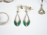 a pair of earrings and a pair of rings on a table