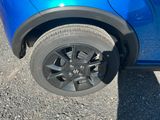 a close up of a blue car with a flat tire