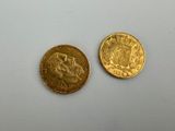 deux pièces d'or posées l'une à côté de l'autre sur une surface blanche