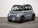 an image of a small electric car on a checkered floor