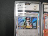 several cards are in plastic cases on a black surface