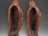 a pair of carved wood sculptures of a man and woman