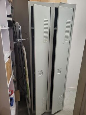 two lockers in the corner of a room next to a closet