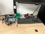 a computer desk with a keyboard, mouse, and a monitor