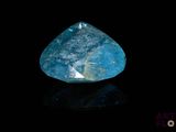 a close up of a blue diamond on a black surface