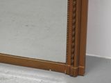 a mirror that is sitting on the floor next to a wall