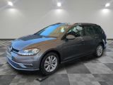 a gray volkswagen golf wagon parked in a garage