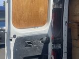 a white van with the door open and a box in the back of it
