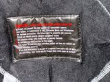 a label on the back of a black jacket