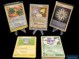 four different types of pokemon cards on display on a black background