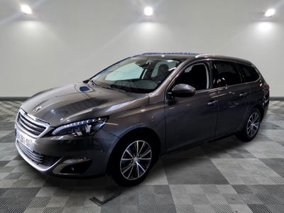 the grey car is parked on a checkered floor in the garage