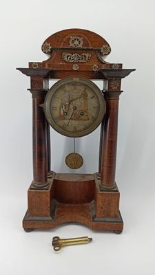 a wooden clock that is sitting on a table