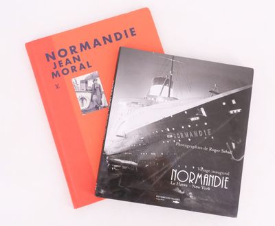 two books sitting on top of each other on a white surface