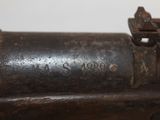 a close up of an old gun with a bullet on it