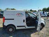 a white van parked in a parking lot with its door open