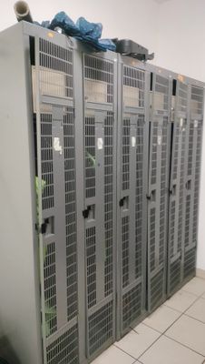 many metal lockers in a room with tile flooring
