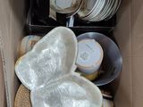 a cardboard box filled with plates and bowls