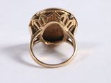 an image of a gold ring with a brown stone in it