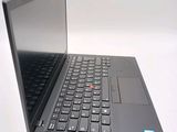 a black laptop with a red button on the keyboard