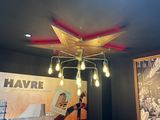 a chandelier with lights hanging from it in a room