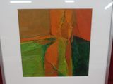 painting in a white frame on a red surface