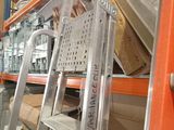 a ladder that is leaning against a wall in a warehouse