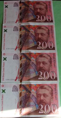 five bills of russian money sitting on top of a green table