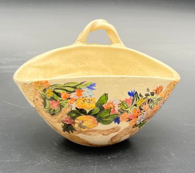 a small bowl with flowers painted on it on a table