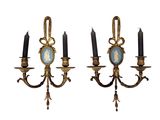 pair of antique wall sconces with a picture of a woman and two candles