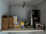 a shelf that has a bunch of boxes on it