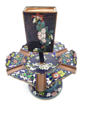 a blue and gold plate with a flower design on it