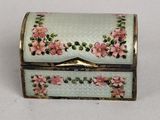 a white box with pink flowers on it sitting on a table