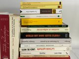 many books stacked on top of each other on a table