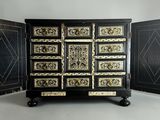 a black and gold chest of drawers in a room