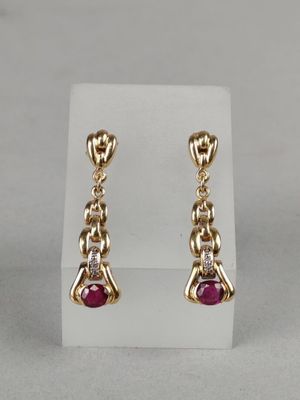 a pair of ruby and diamond earrings