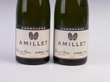 two bottles of champagne are sitting next to each other on a table