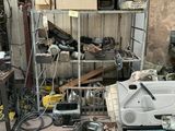 a picture of a garage with a lot of junk on the floor