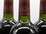 three bottles of wine are lined up on a table
