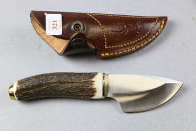 a knife that is sitting next to a knife holder