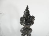 a silver statue of a man and a woman sitting on a pedestal